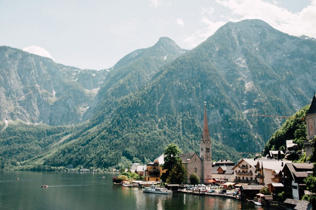 village beside lake near mountain ranges